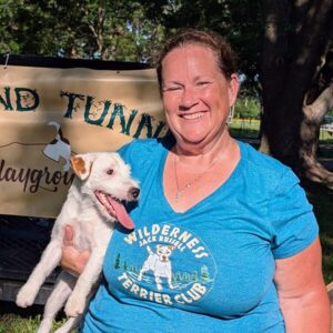 A woman holding a dog.